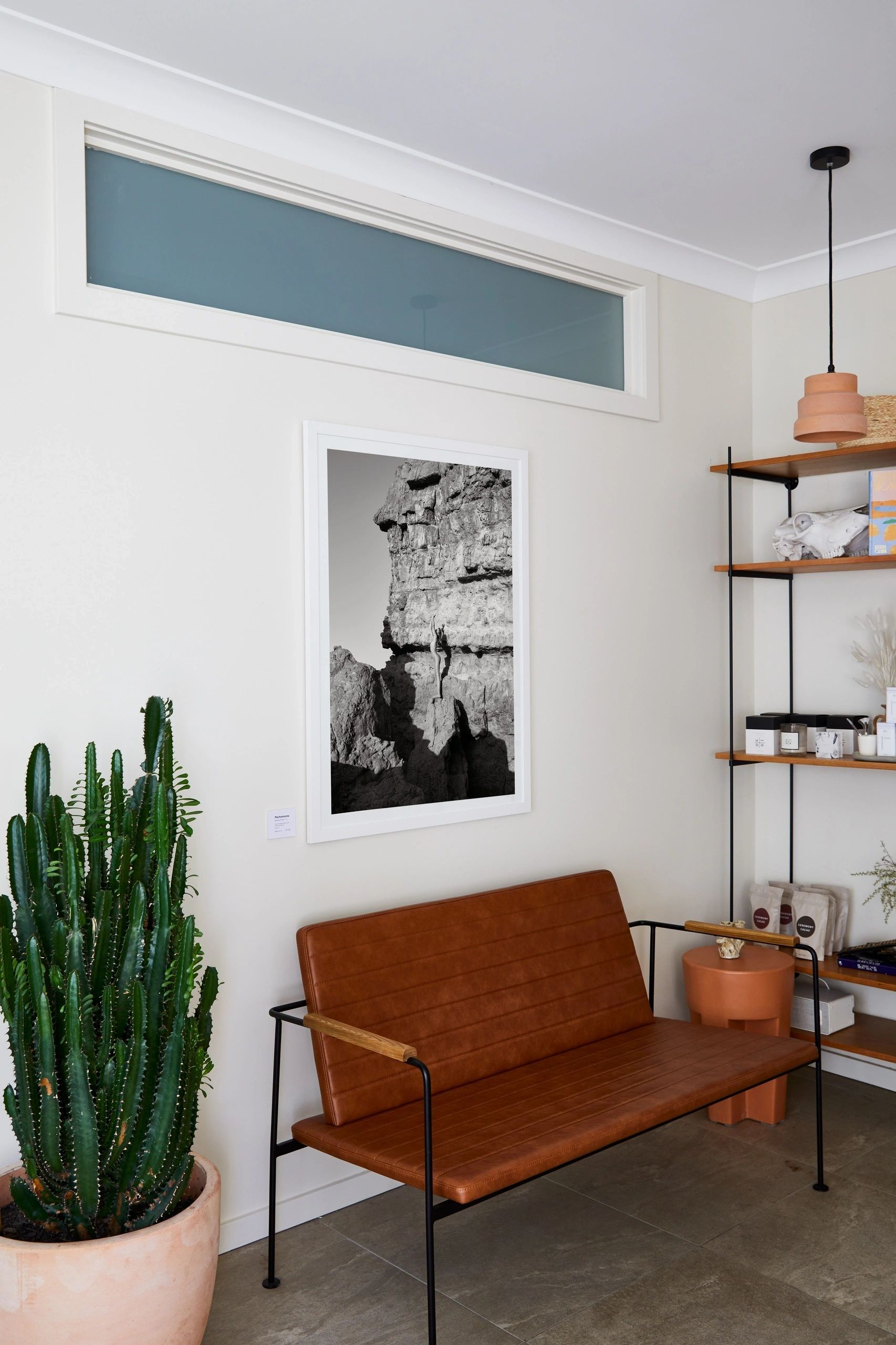 Pachamama, Monica Pronk’s black-and-white photograph, framed on the wall of the Mesa studio beside a tan leather bench and a potted cactus.